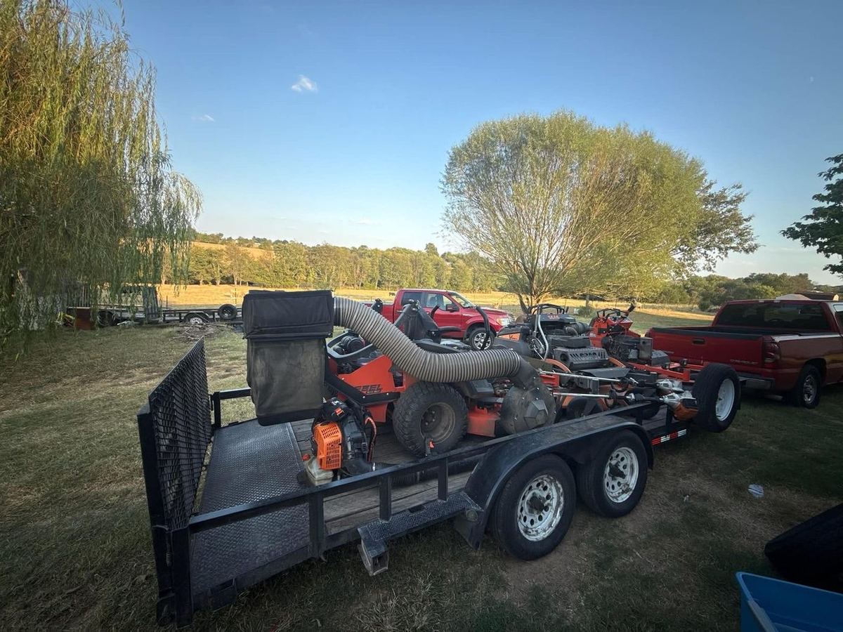 Trailer loaded with commercial mowers, ready for the route